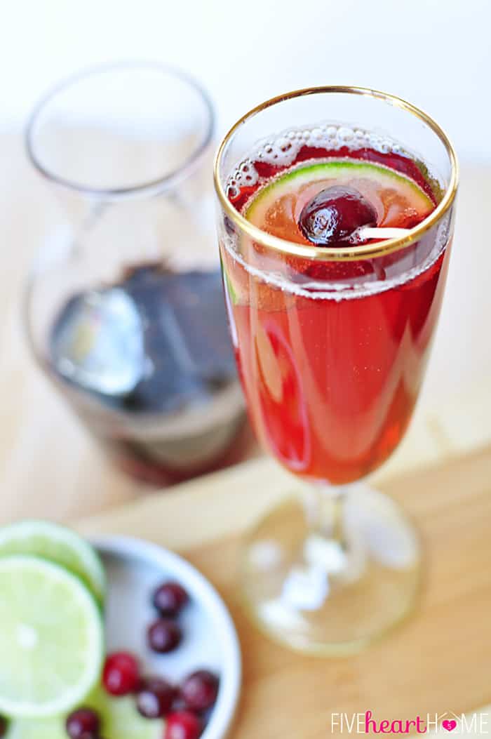 Cranberry Pomegranate Bellini with jar of simple syrup in background.