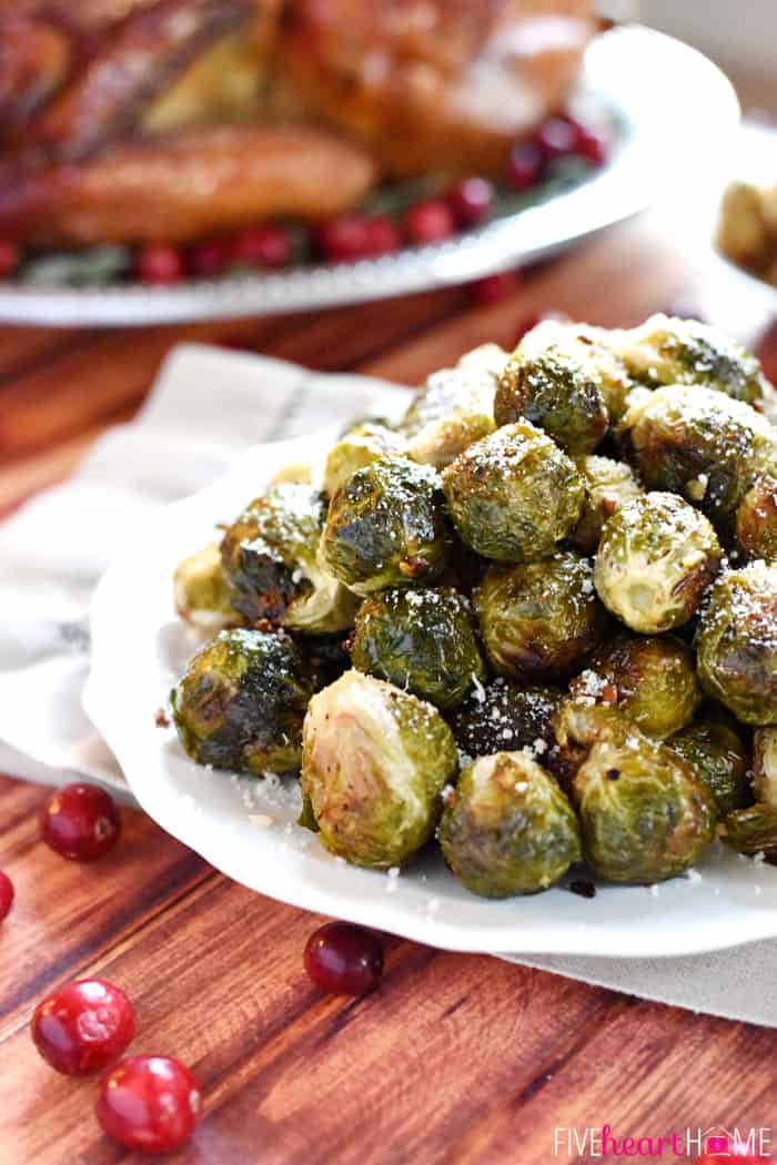 Roasted Brussels Sprouts with Parmesan Piled High on a White Scalloped Platter 