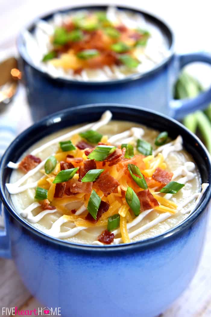Two blue bowls of Loaded Baked Potato Soup.