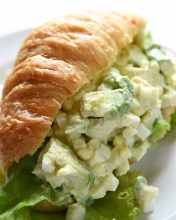 Close-up of Avocado Egg Salad on croissant.