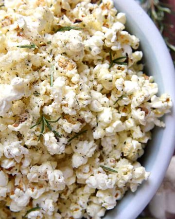 Rosemary Parmesan Popcorn ~ freshly-popped popcorn is drizzled with rosemary- and garlic-inflused olive oil and sprinkled with grated Parmesan, minced rosemary, garlic salt, and black pepper, making this recipe a flavorful snack for parties, munching, or movie watching! | FiveHeartHome.com