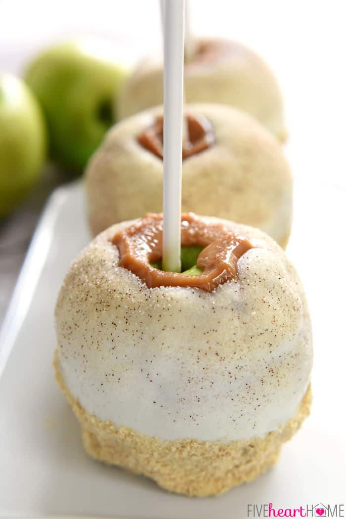 Three Disney Caramel Apples in a row on a white platter