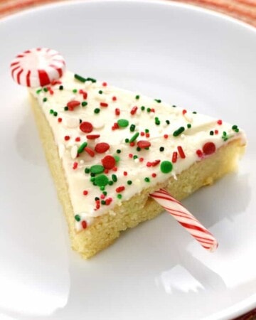 Christmas Sheet Cake on plate with peppermint star and candy cane trunk.