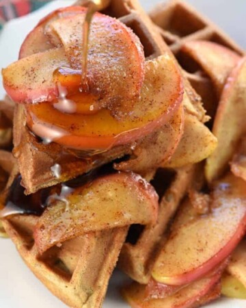 Apple Cinnamon Waffles with syrup being poured on top.