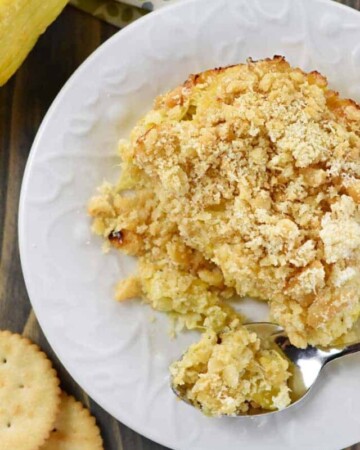 Aerial view of Squash Casserole on plate with spoon.