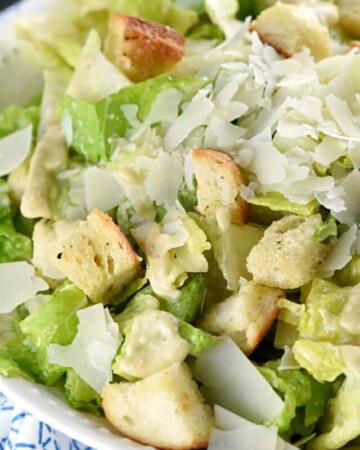 Classic Caesar Salad ~ with a flavorful (egg-free!) dressing, garlicky homemade croutons, and fresh shaved Parmesan atop crunchy hearts of romaine, this is the perfect side to just about any meal...or top with sliced chicken for a healthy, hearty entree! | FiveHeartHome.com