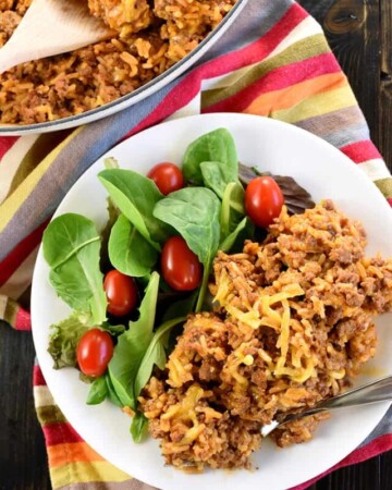 Aerial view of homemade Taco Hamburger Helper on plate and in skillet.