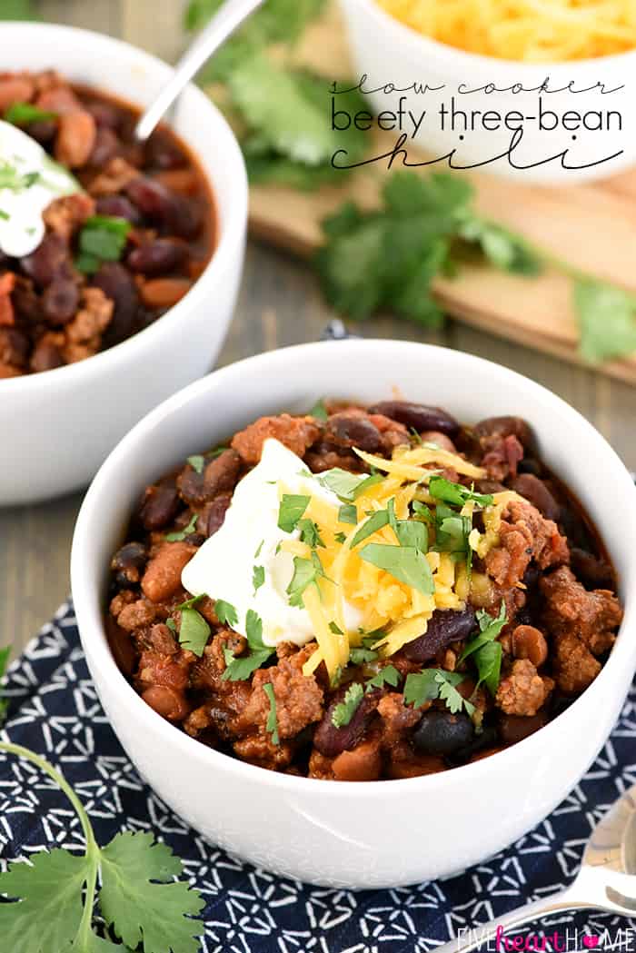 Slow Cooker Beefy Three-Bean Chili ~ a chunky, hearty, flavorful bowl of crock pot comfort food goodness, easy to adjust to your preferred spice level and delicious topped with sour cream, shredded cheese, and fresh cilantro! | FiveHeartHome.com