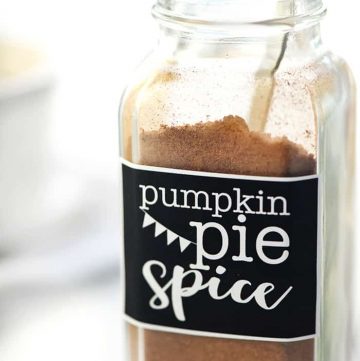 Pumpkin Pie Spice in a labeled spice bottle with measuring spoon