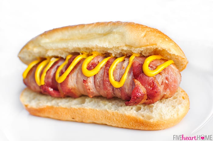 Bacon Wrapped Hot Dogs with Cheese on a bun