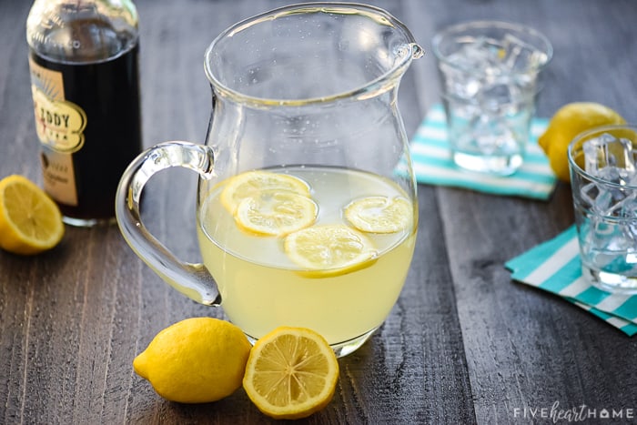 Lemonade with bottle of sweet tea vodka in background.