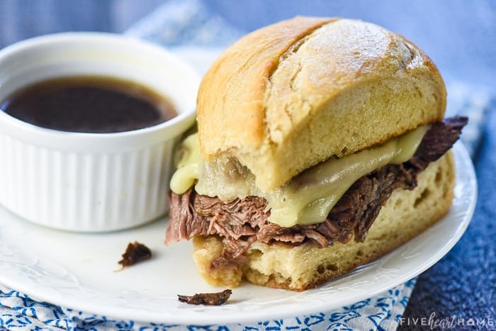Slow Cooker French Dip ~ this crock pot recipe features succulent beef slow cooked in a flavorful broth, served on toasty rolls with melted cheese and extra au jus for dipping! | FiveHeartHome.com