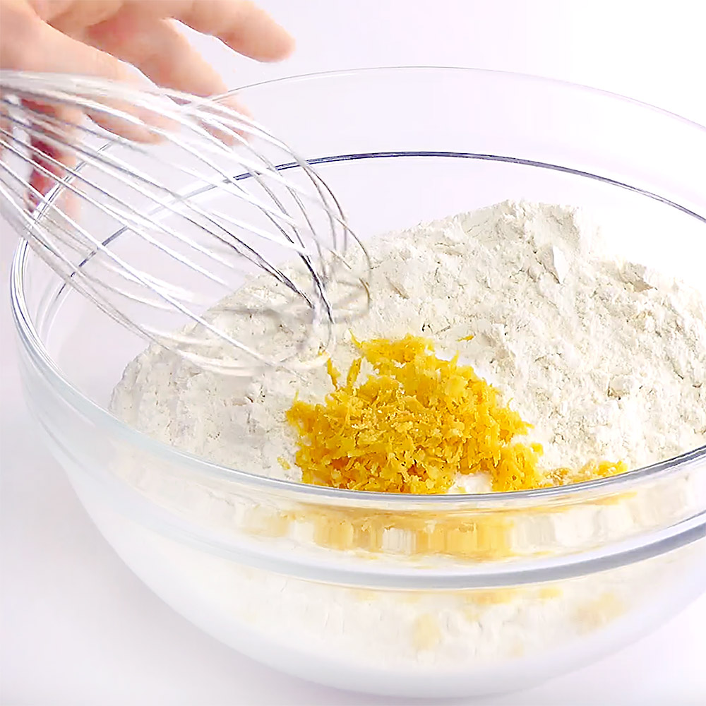 Whisking dry ingredients and lemon zest.