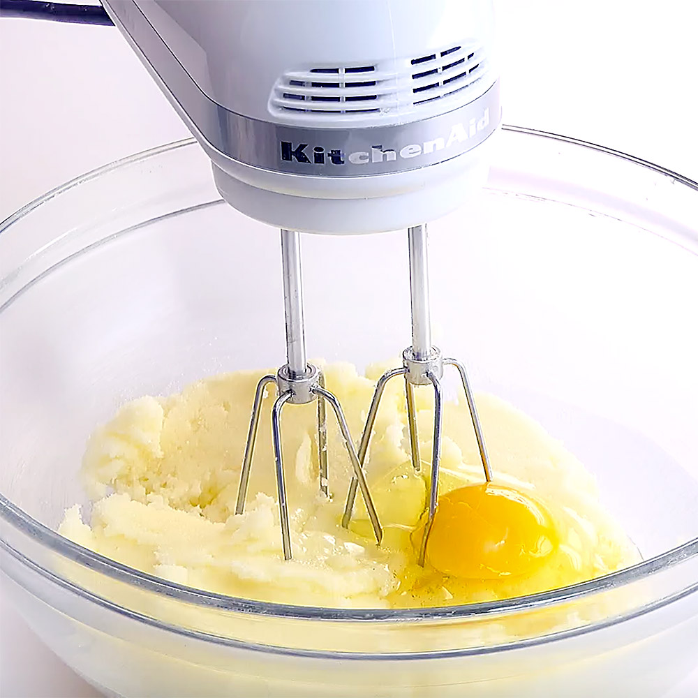 Blending eggs into batter.