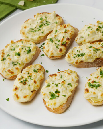 Artichoke Bruschetta on white platter.