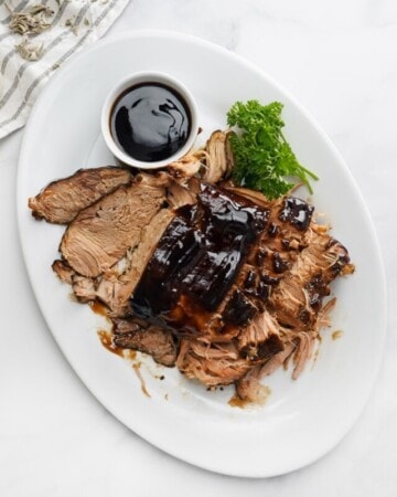 Aerial view of Crock Pot Pork Loin on platter with glaze.