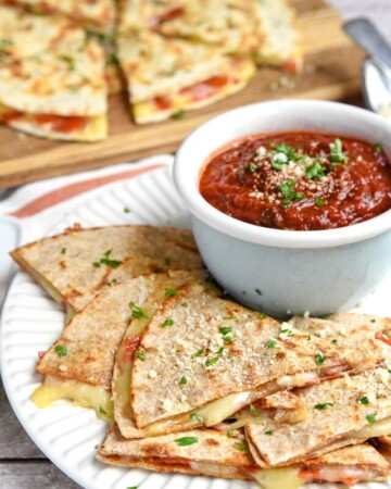 Pizza Quesadillas, or Pizzadillas, on plate with pizza sauce for dipping.
