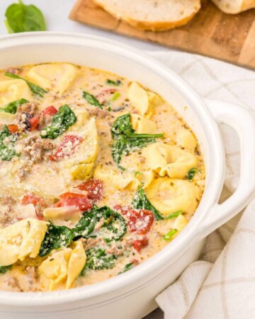 Close-up of Sausage Tortellini Soup in white pot.