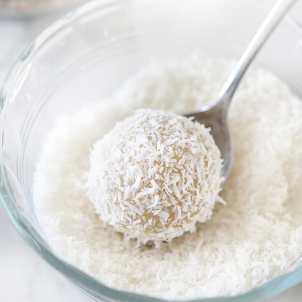 Coating thumbprint cookie recipe with coconut.