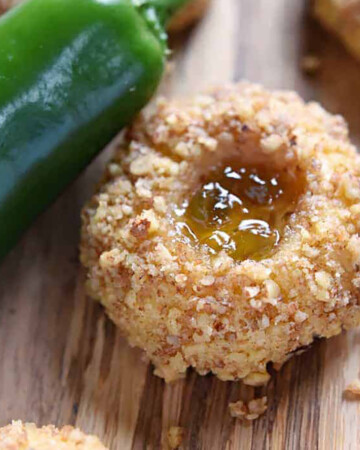 Savory Thumbprint Cookies with pepper jelly, cheddar, and nuts, plus a fresh jalapeño on the table.