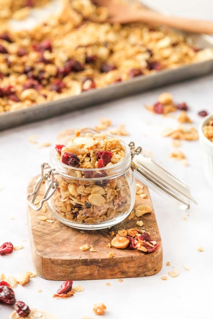 Homemade granola recipe on pan and in jar.